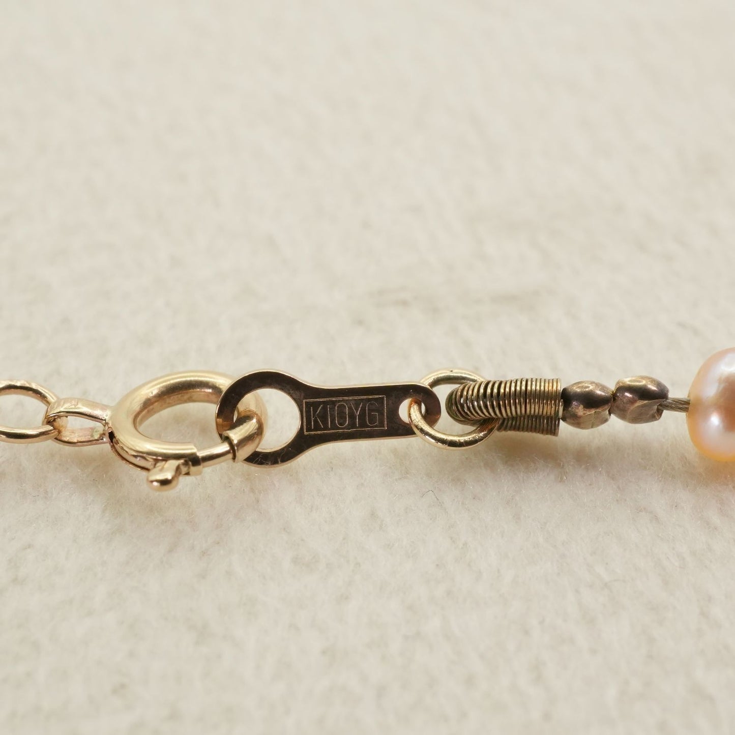 Agete K10 gold long necklace featuring pink freshwater pearls displayed on white background