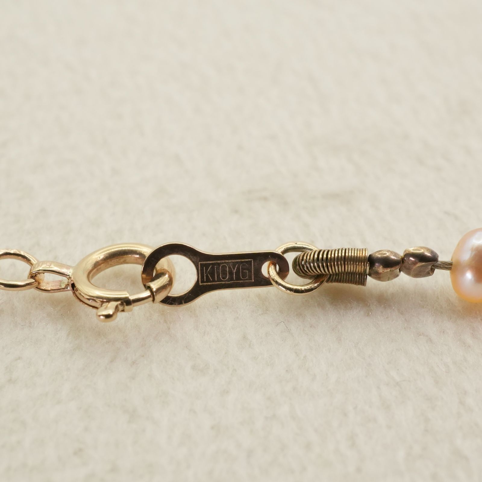 Agete K10 gold long necklace featuring pink freshwater pearls displayed on white background