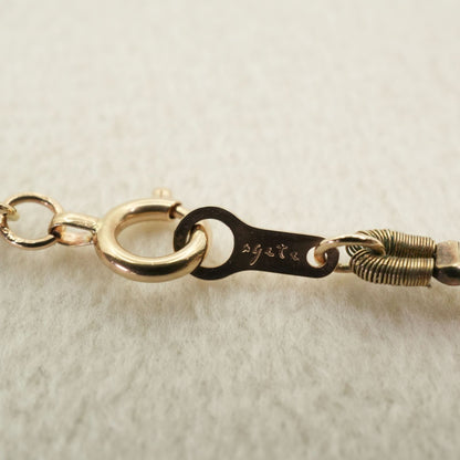 Agete K10 gold long necklace featuring pink freshwater pearls displayed on white background