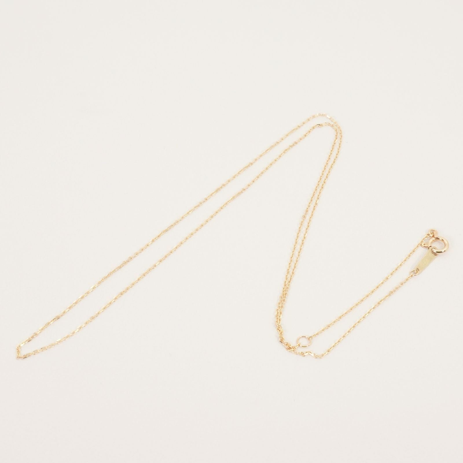Agete K10 gold necklace chain laid out showing its fine links and polished finish
