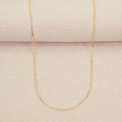 Agete K10 gold necklace chain laid out showing its fine links and polished finish