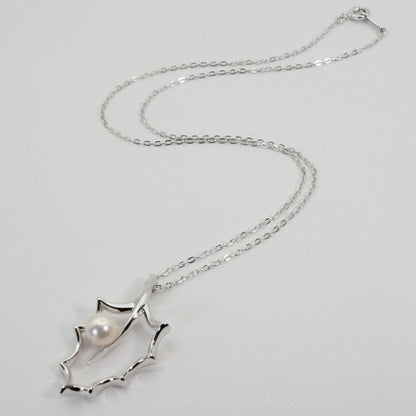 Mikimoto Hollyhock necklace featuring a silver chain and a single pearl pendant with floral design