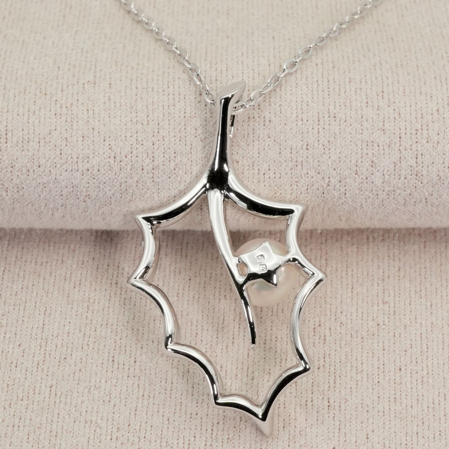 Mikimoto Hollyhock necklace featuring a silver chain and a single pearl pendant with floral design