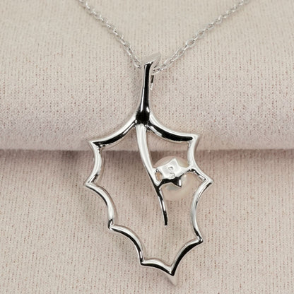 Mikimoto Hollyhock necklace featuring a silver chain and a single pearl pendant with floral design