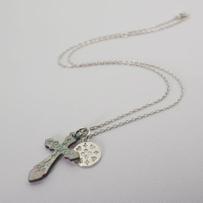 Agete silver necklace with a round shell cross charm on a delicate chain