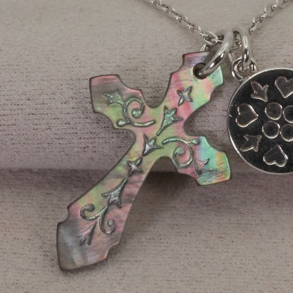 Agete silver necklace with a round shell cross charm on a delicate chain
