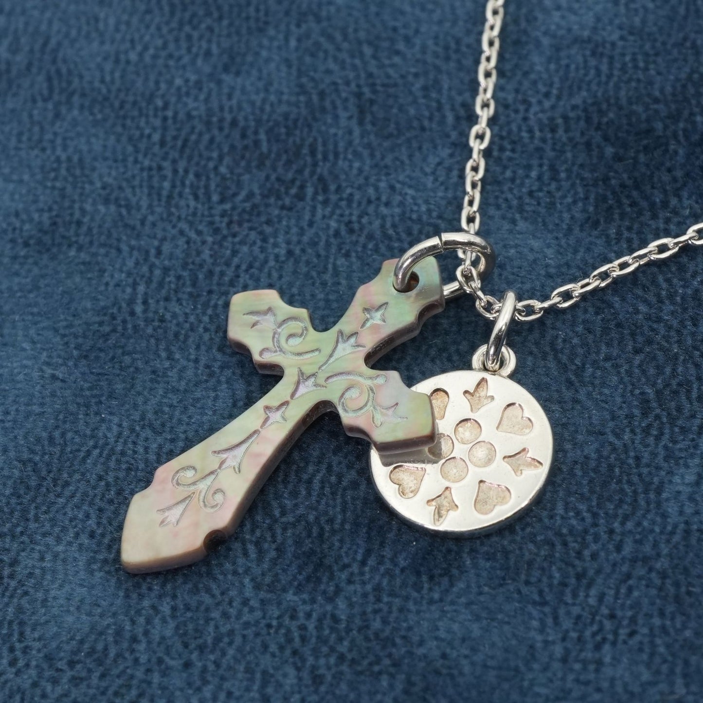 Agete silver necklace with a round shell cross charm on a delicate chain