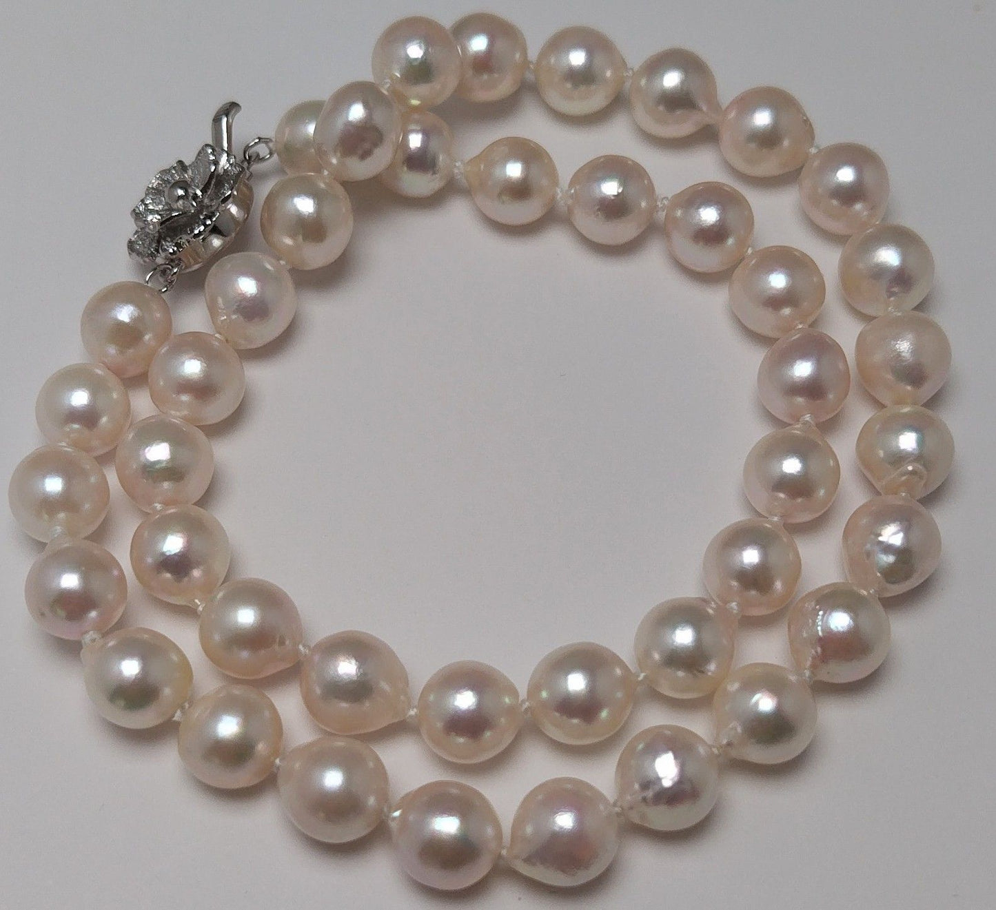 Akoya pearl necklace featuring 9.0-8.5mm white pink semi baroque pearls with unique indentations and good luster