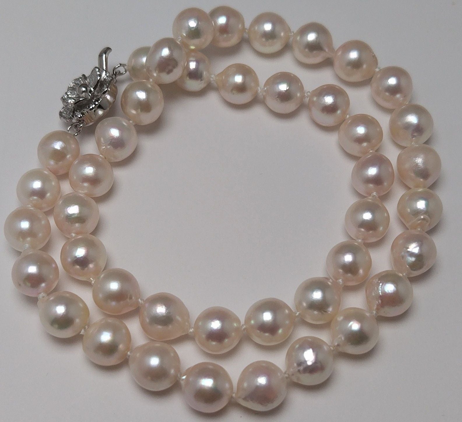 Akoya pearl necklace featuring 9.0-8.5mm white pink semi baroque pearls with unique indentations and good luster