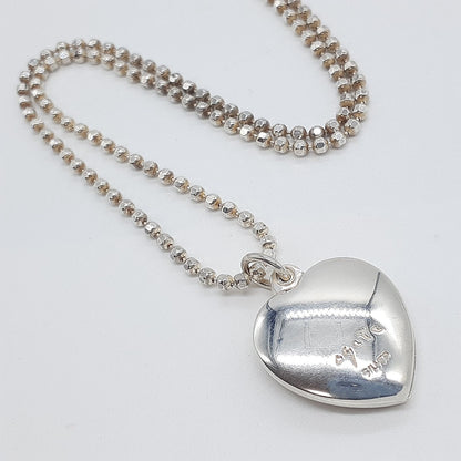 Agete heart-shaped silver necklace with heart rocket and clover charm on silver chain