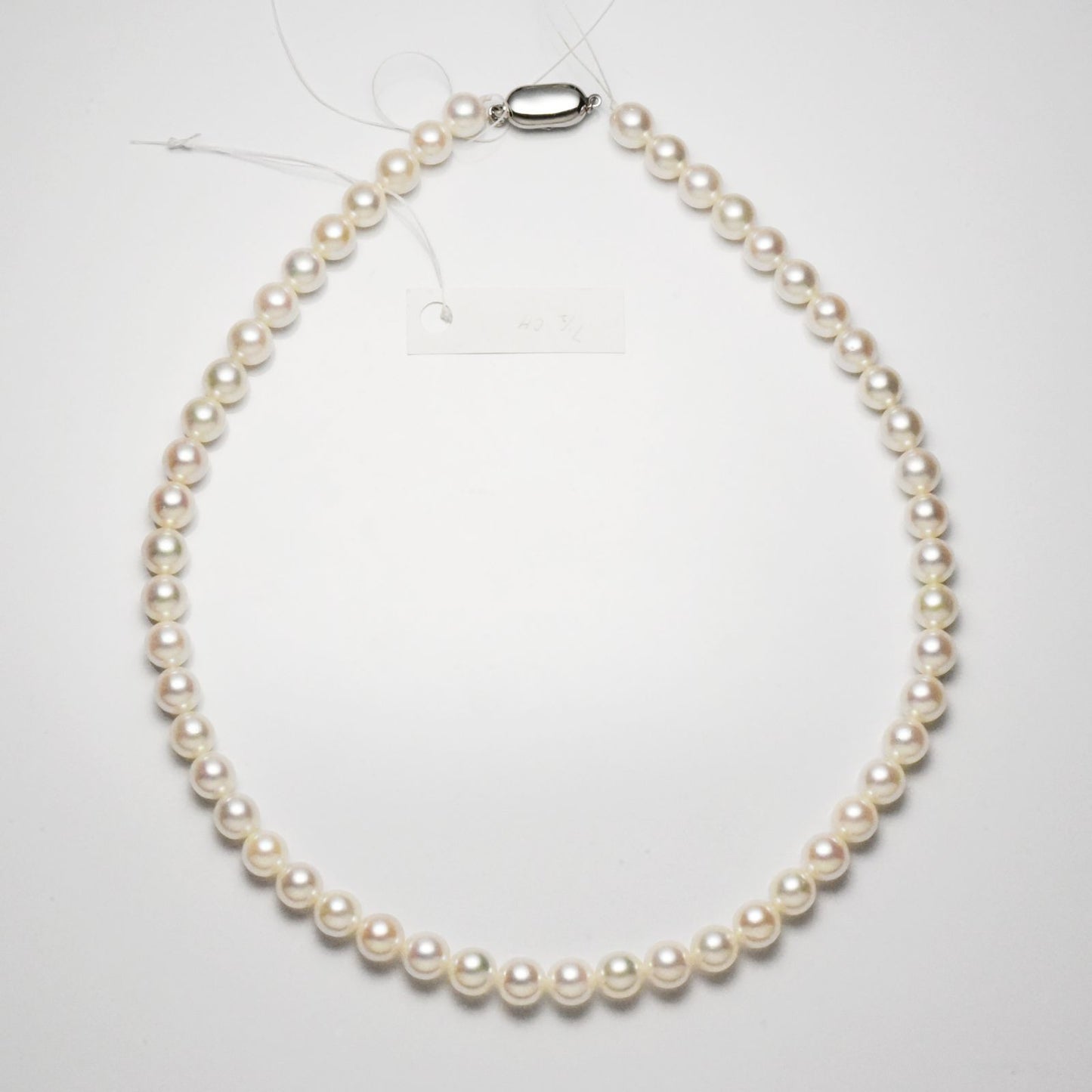 Akoya pearl necklace with 7.5-8mm pearls measuring 42cm in length on a white background