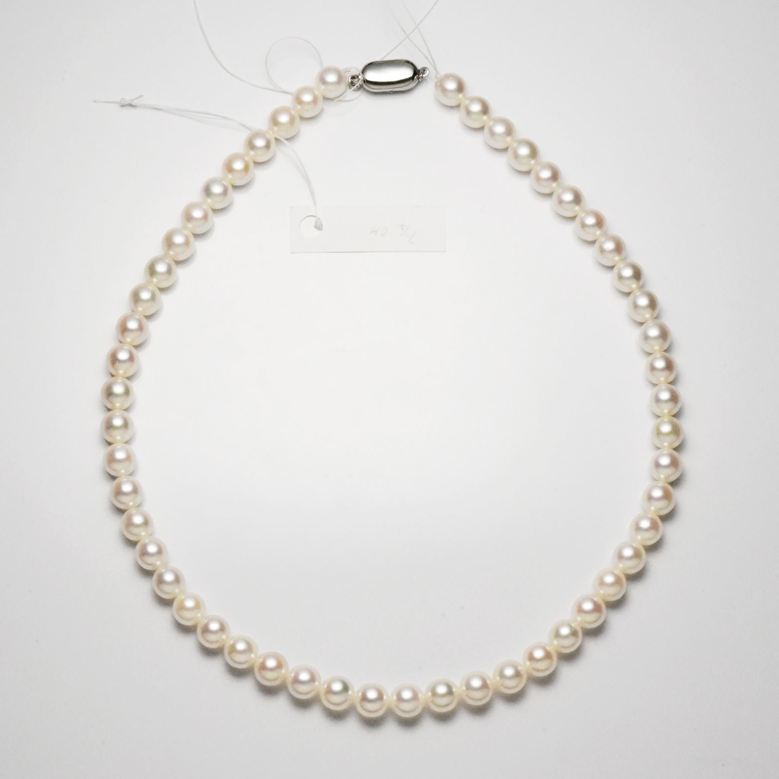 Akoya pearl necklace with 7.5-8mm pearls measuring 42cm in length on a white background