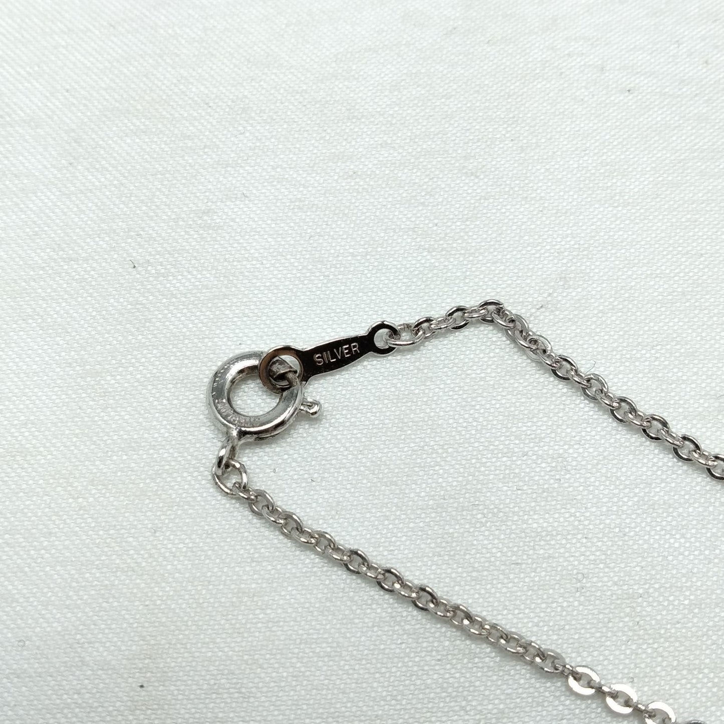 MIKIMOTO silver heart necklace with a 0.5cm pearl pendant and 19cm chain on white background