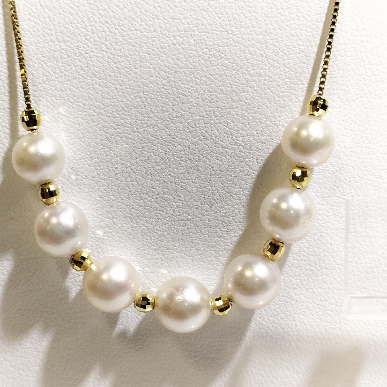Akoya pearl necklace with 7-7.5 mm pearls and matching 7.5 mm pearl earrings on white background