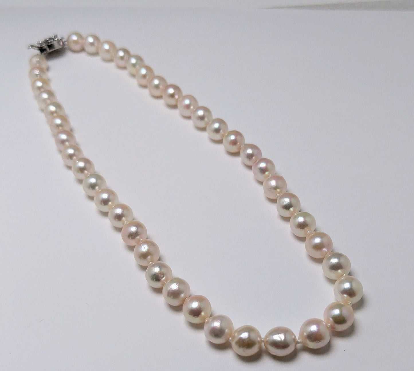 Akoya pearl necklace featuring 9.0-8.5mm white pink semi baroque pearls with unique indentations and good luster