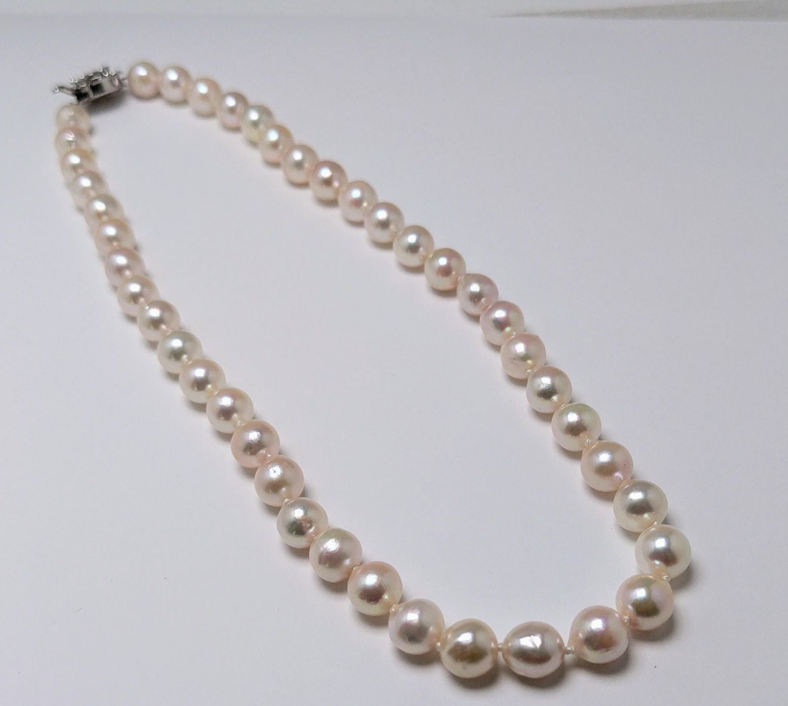 Akoya pearl necklace featuring 9.0-8.5mm white pink semi baroque pearls with unique indentations and good luster