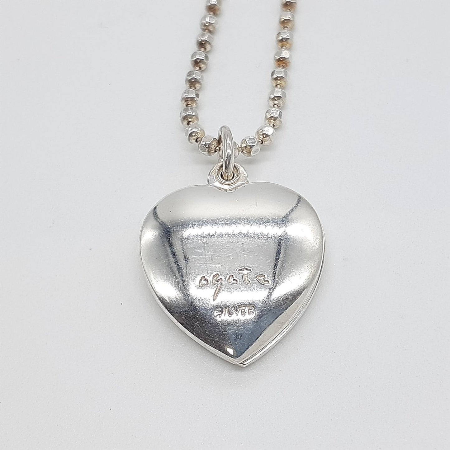 Agete heart-shaped silver necklace with heart rocket and clover charm on silver chain