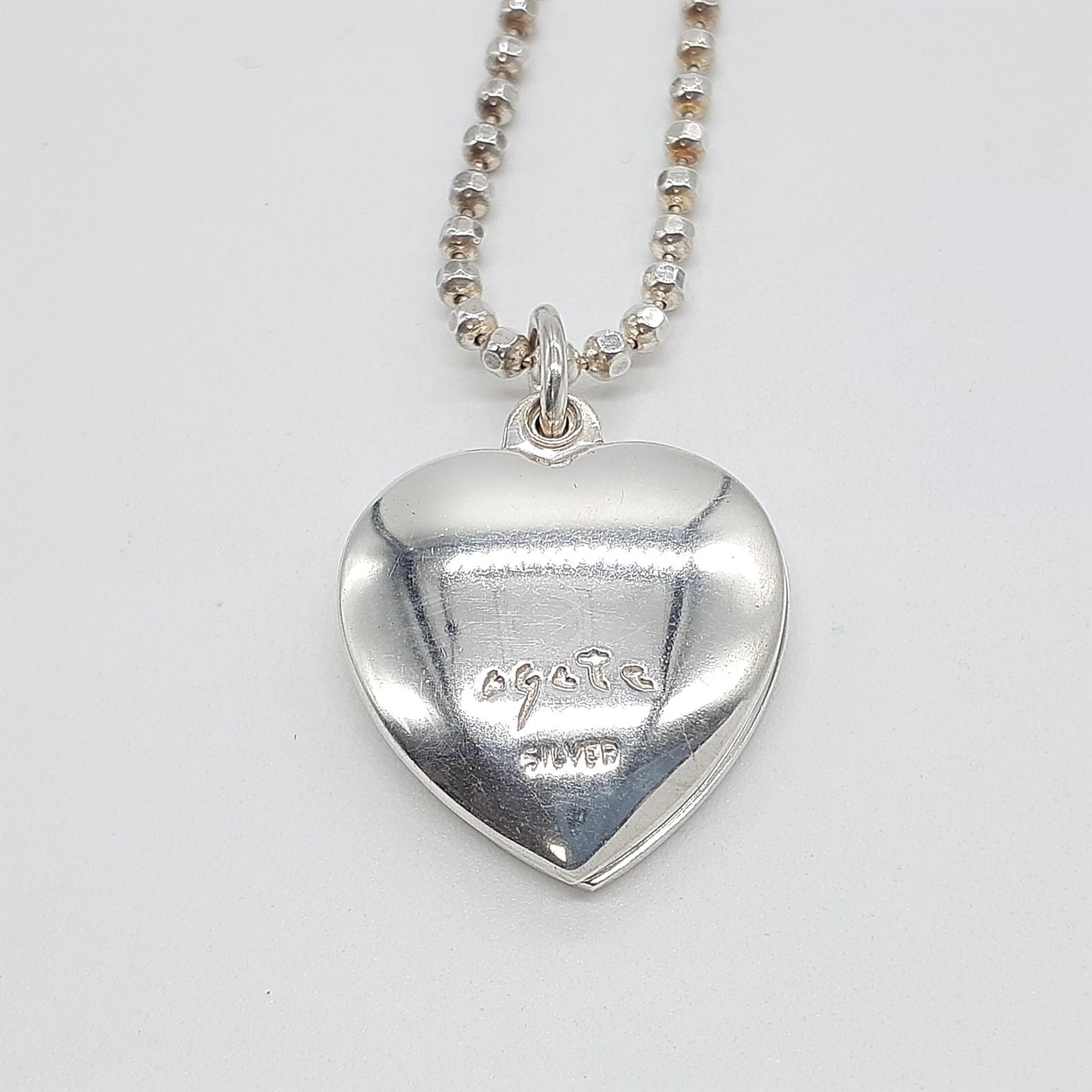 Agete heart-shaped silver necklace with heart rocket and clover charm on silver chain