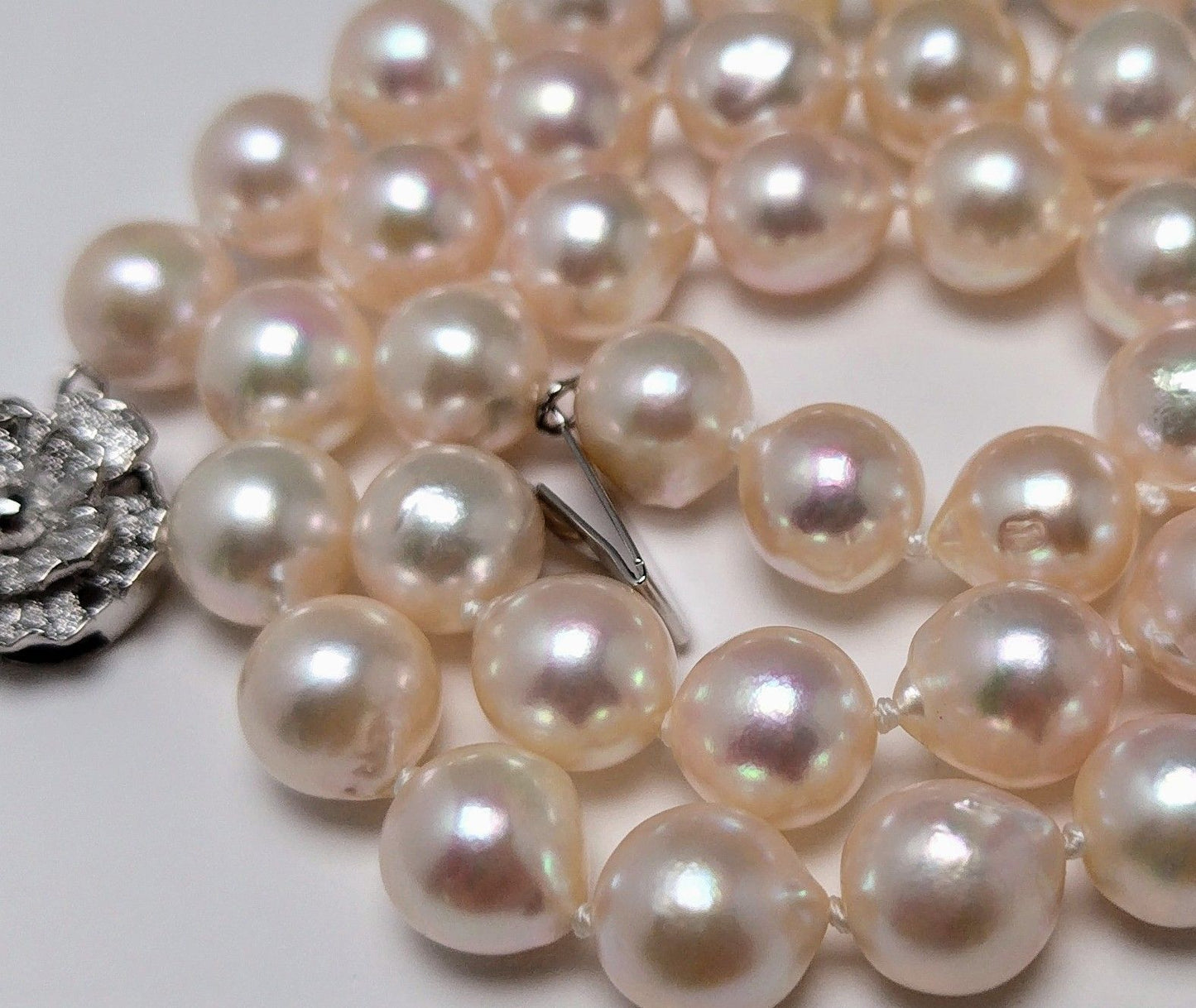Akoya pearl necklace featuring 9.0-8.5mm white pink semi baroque pearls with unique indentations and good luster