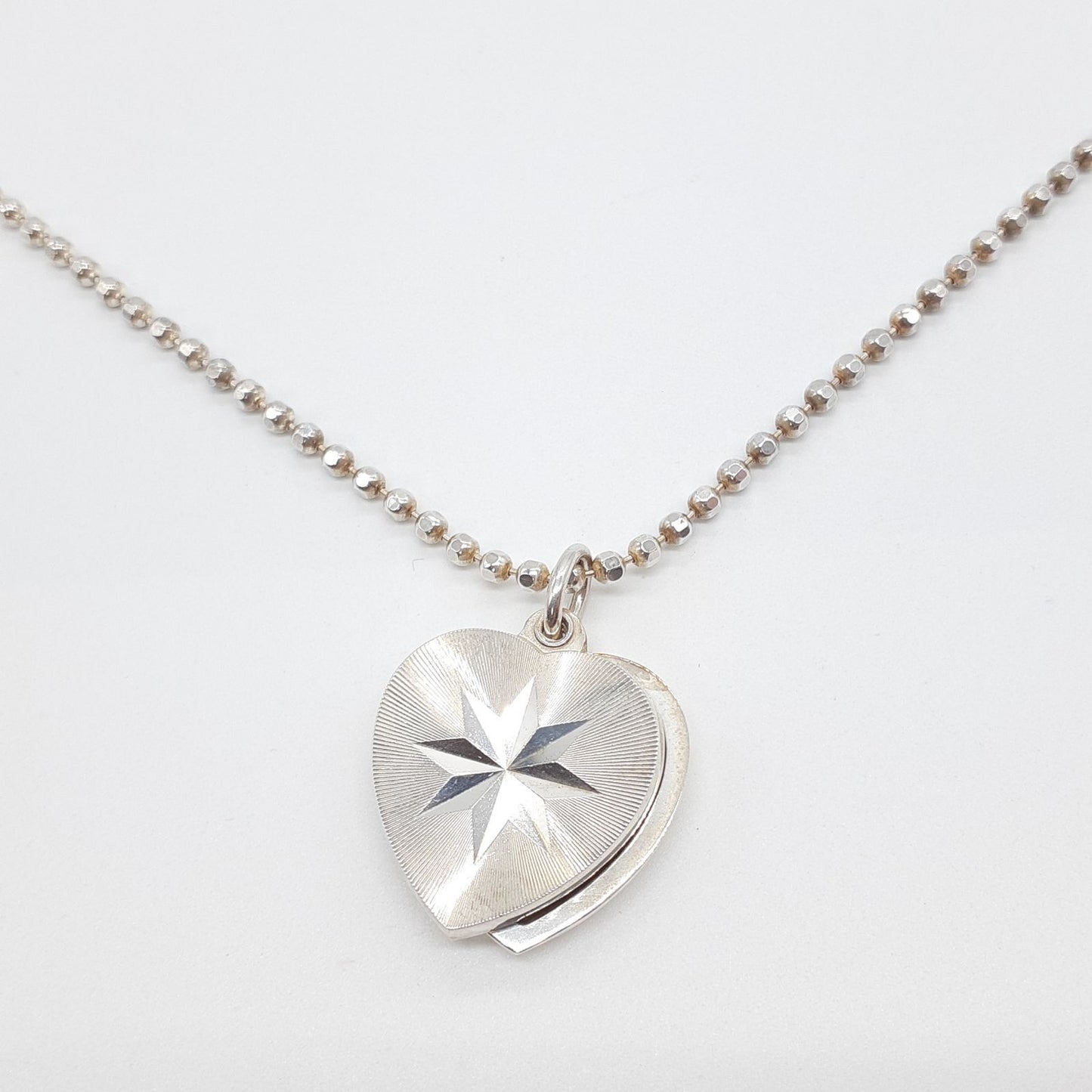 Agete heart-shaped silver necklace with heart rocket and clover charm on silver chain
