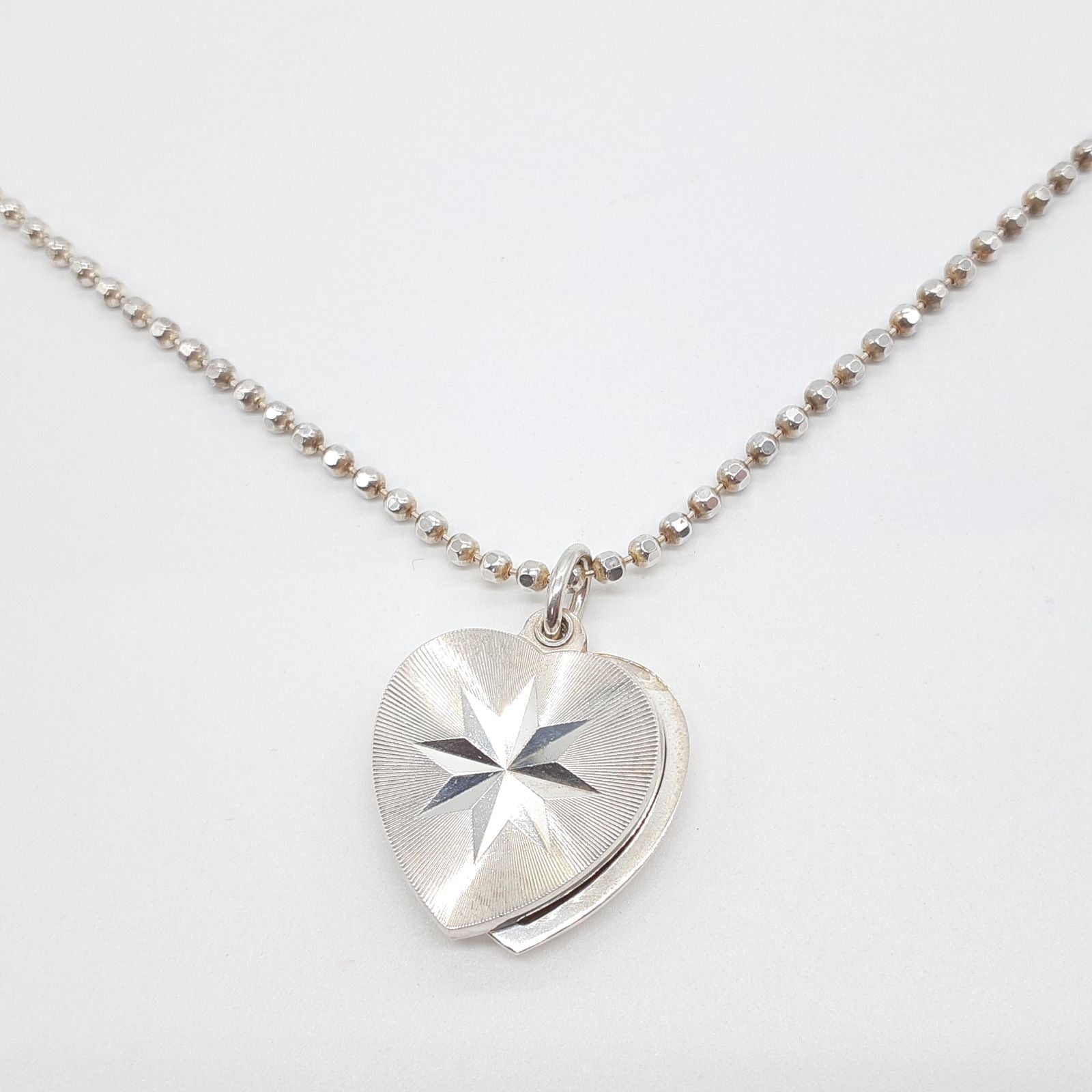Agete heart-shaped silver necklace with heart rocket and clover charm on silver chain