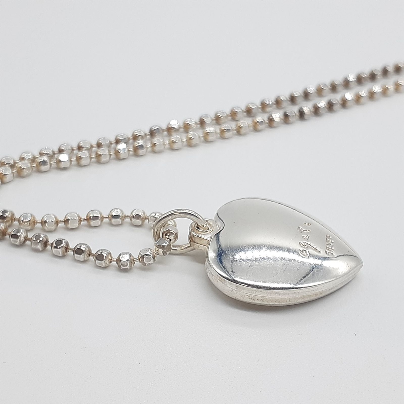 Agete heart-shaped silver necklace with heart rocket and clover charm on silver chain