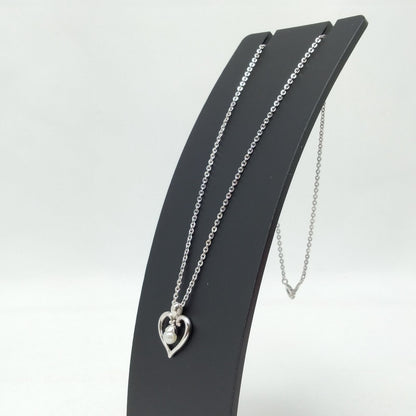 MIKIMOTO silver heart necklace with a 0.5cm pearl pendant and 19cm chain on white background
