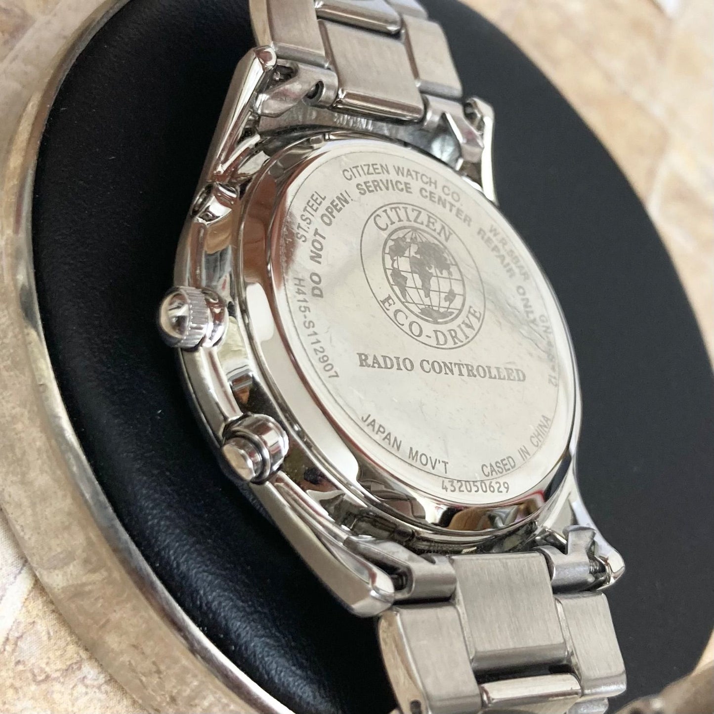 Citizen Eco-Drive men's radio-controlled watch model H415-S112907 with silver case and black band