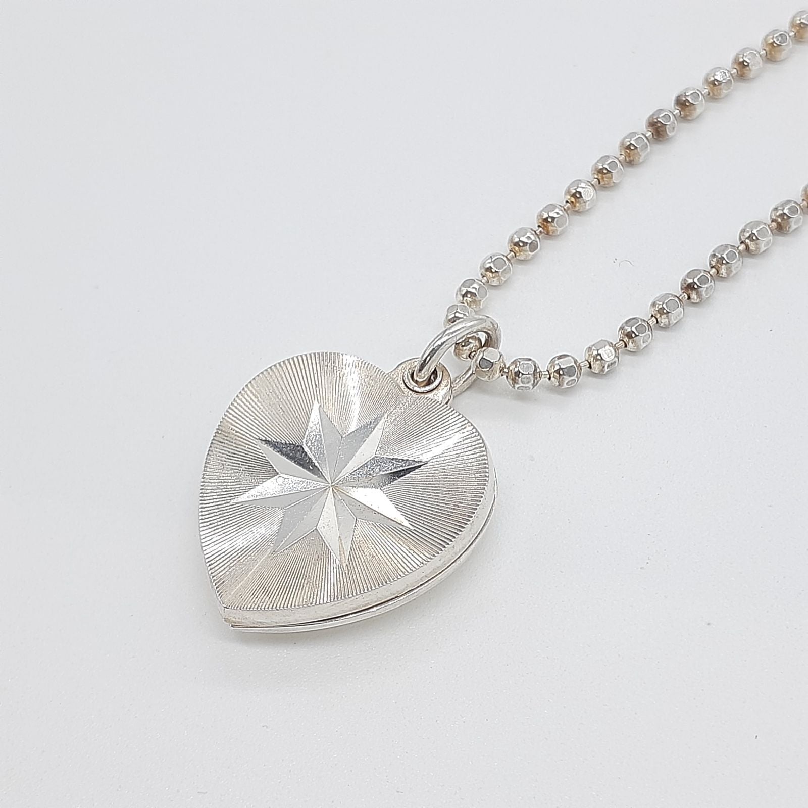 Agete heart-shaped silver necklace with heart rocket and clover charm on silver chain