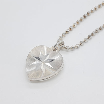 Agete heart-shaped silver necklace with heart rocket and clover charm on silver chain