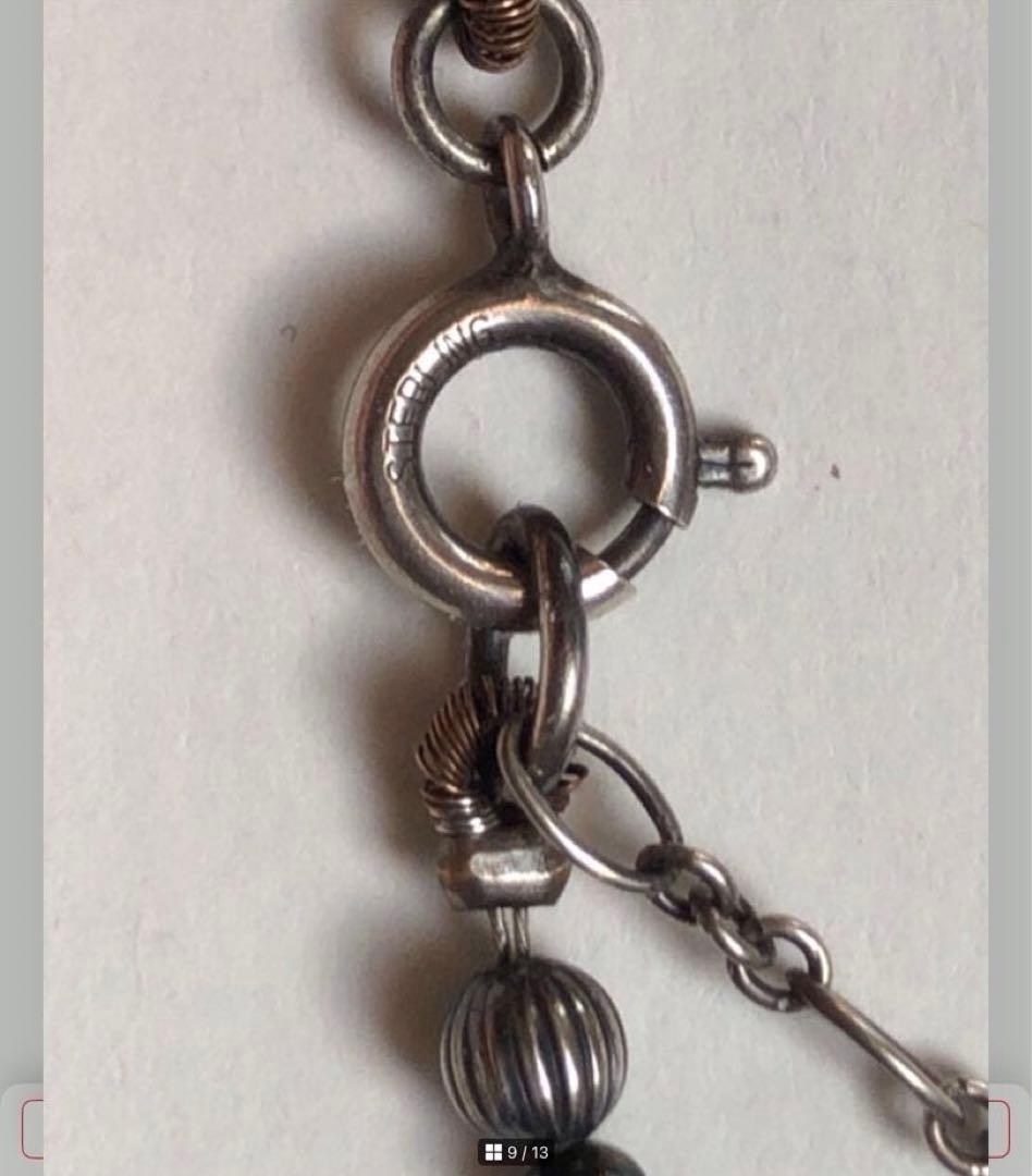 Agete SV Agate long sterling silver necklace with cross charm on white background