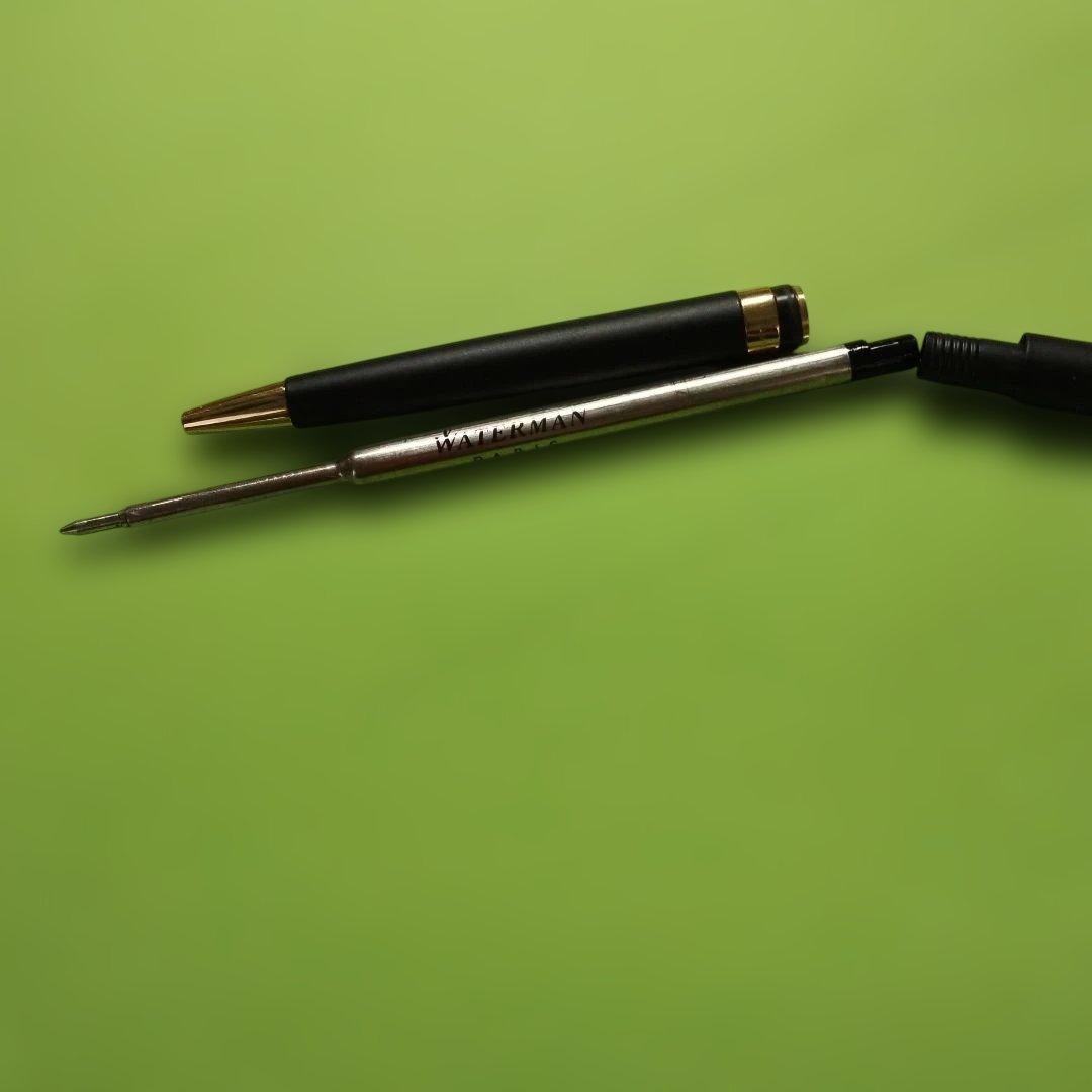 WATERMAN ballpoint pen in matte black with gold trim shown on white background
