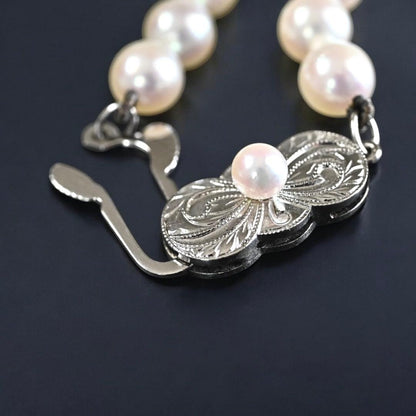 Hana-dama grade Mikimoto Akoya pearl necklace with round 6-5.5mm pearls and silver clasp in aurora pink color