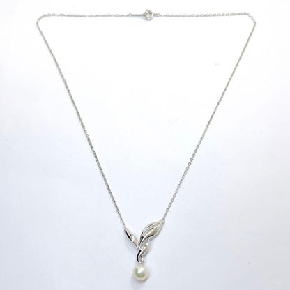 Mikimoto pearl necklace featuring a 6.7mm pearl and silver leaf pendant on a 42cm chain