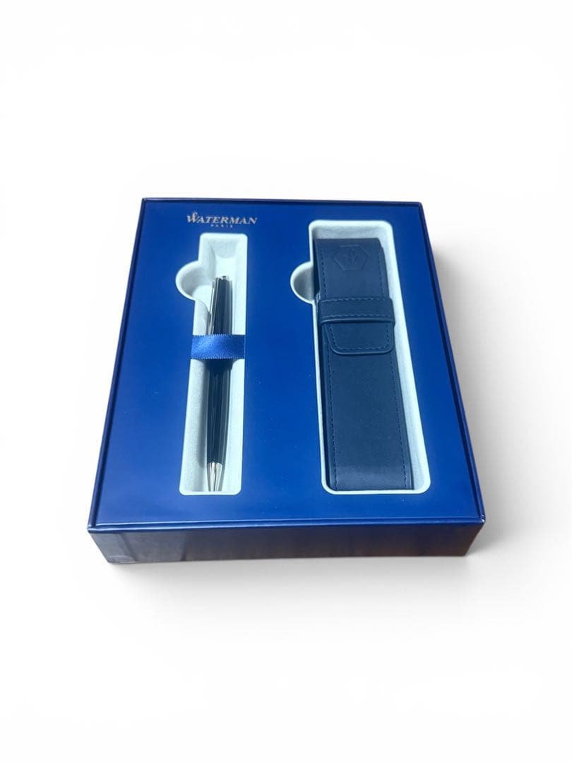 WATERMAN ballpoint pen with black body and blue dedicated pen case set on white background