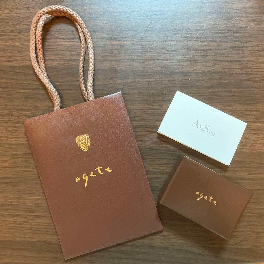 Agete K10 yellow gold charm necklace featuring a sparkling diamond pendant