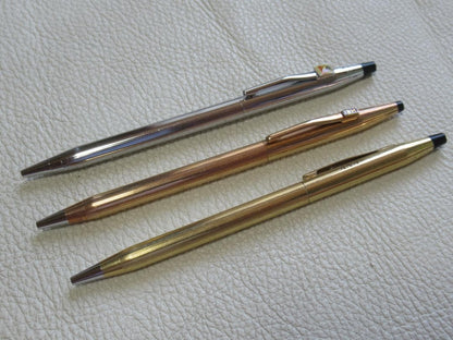 Set of three Cross Classic Century metal ballpoint pens on white background