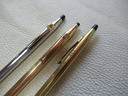 Set of three Cross Classic Century metal ballpoint pens on white background