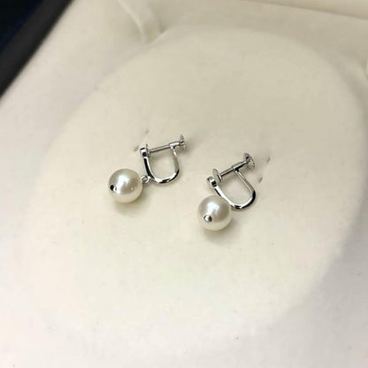 Large white Akoya pearl necklace and matching earrings with 8.5mm pearls and silver accents on white background