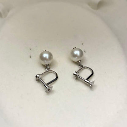 Large white Akoya pearl necklace and matching earrings with 8.5mm pearls and silver accents on white background