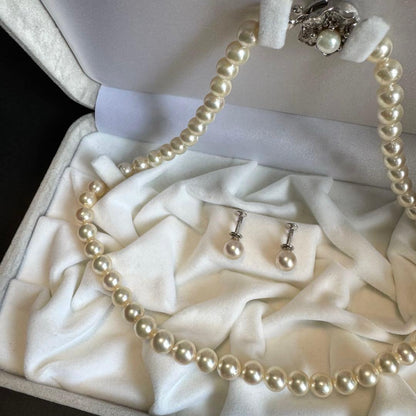 Akoya pearl necklace and earrings set featuring 7.3mm white and cream pearls displayed without accessory case