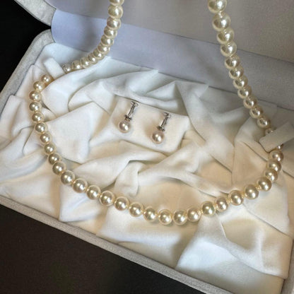 Akoya pearl necklace and earrings set featuring 7.3mm white and cream pearls displayed without accessory case