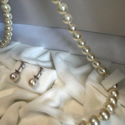 Akoya pearl necklace and earrings set featuring 7.3mm white and cream pearls displayed without accessory case