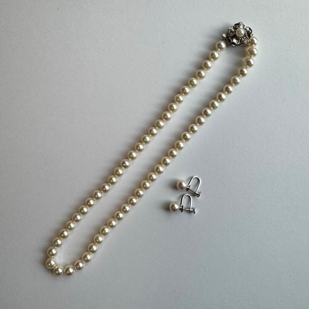 Akoya pearl necklace and earrings set featuring 7.3mm white and cream pearls displayed without accessory case