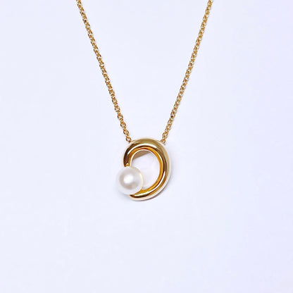 Tasaki pearl necklace pendant with 6.4 mm silver pearl and 45 cm gold chain on white background