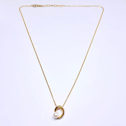 Tasaki pearl necklace pendant with 6.4 mm silver pearl and 45 cm gold chain on white background