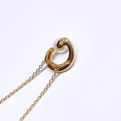Tasaki pearl necklace pendant with 6.4 mm silver pearl and 45 cm gold chain on white background