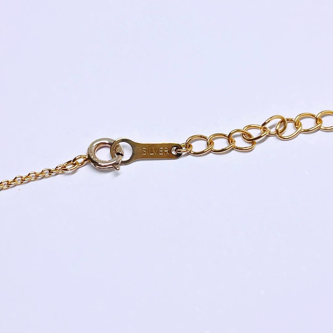Tasaki pearl necklace pendant with 6.4 mm silver pearl and 45 cm gold chain on white background