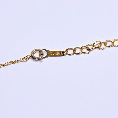 Tasaki pearl necklace pendant with 6.4 mm silver pearl and 45 cm gold chain on white background