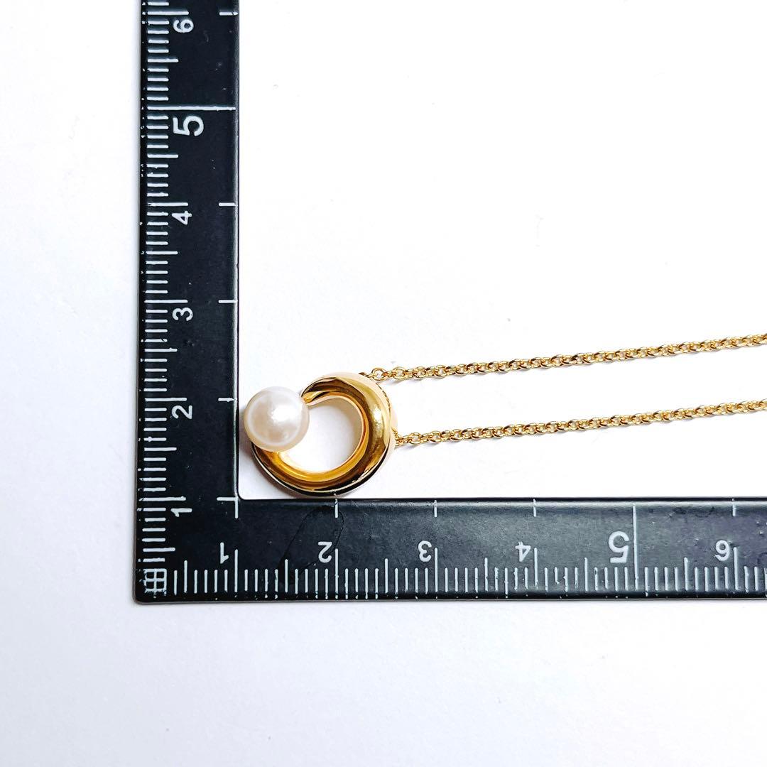 Tasaki pearl necklace pendant with 6.4 mm silver pearl and 45 cm gold chain on white background